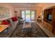 Living room with sofa, rug, and access to backyard at 2530 Saffron Ln, The Villages, FL 32162