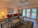 Living room with grey sofa and access to patio at 2530 Saffron Ln, The Villages, FL 32162