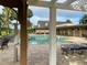 Community pool with lounge chairs and clubhouse view at 2530 Saffron Ln, The Villages, FL 32162