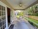 Relaxing screened porch with outdoor seating and ceiling fan at 2530 Saffron Ln, The Villages, FL 32162