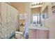 Clean bathroom with shower/tub combo, wood vanity, and updated fixtures at 2740 Coupe St, Kissimmee, FL 34746