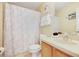 Bathroom with shower/tub combo, wood vanity, and updated fixtures at 2740 Coupe St, Kissimmee, FL 34746