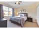 Main bedroom with a king-size bed, nightstands, and large window at 2740 Coupe St, Kissimmee, FL 34746