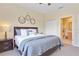 Bedroom with king-size bed, attached bathroom access, and gray bedding at 2740 Coupe St, Kissimmee, FL 34746