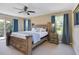 Main bedroom with a large bed, plenty of closet space, and access to a balcony at 2740 Coupe St, Kissimmee, FL 34746