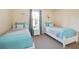 Bedroom with two twin beds, window, and ample closet space at 2740 Coupe St, Kissimmee, FL 34746