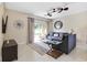 Living area with gray sofas, a large window, and sliding doors to the patio at 2740 Coupe St, Kissimmee, FL 34746