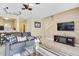 Living room with gray sofa, media console, and a view of the kitchen at 2740 Coupe St, Kissimmee, FL 34746