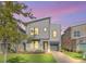 Modern two-story home with gray siding, a gray roof and a landscaped lawn at 2748 Bookmark Dr, Kissimmee, FL 34746