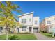 Modern two-story house with light beige siding, gray roof and a landscaped front yard at 2748 Bookmark Dr, Kissimmee, FL 34746