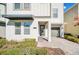 Front entrance with dark gray door, a gray awning and brick pavers at 2748 Bookmark Dr, Kissimmee, FL 34746