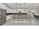 Modern kitchen with white cabinets, large island, and stainless steel appliances at 2748 Bookmark Dr, Kissimmee, FL 34746