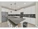 Modern kitchen with white cabinets, large island, and stainless steel appliances at 2748 Bookmark Dr, Kissimmee, FL 34746