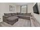 Cozy living room with sectional sofa and large TV at 2748 Bookmark Dr, Kissimmee, FL 34746
