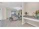 Living room with light beige sofa, accent chairs, and a large TV at 2748 Bookmark Dr, Kissimmee, FL 34746