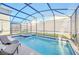 Screened-in pool and spa with comfortable seating at 2748 Bookmark Dr, Kissimmee, FL 34746