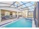 Enclosed pool and spa area with lounge chairs at 2748 Bookmark Dr, Kissimmee, FL 34746