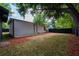 Fenced backyard features mature trees, mulch, and a grassy area at 2803 E Pine St, Orlando, FL 32803