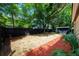 Spacious backyard with mature trees provides ample shade; enclosed with a modern, black-stained fence at 2803 E Pine St, Orlando, FL 32803