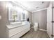 Bright bathroom with double sinks, modern fixtures, and wood-look tile flooring at 2803 E Pine St, Orlando, FL 32803