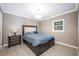 Comfortable bedroom with a queen-size bed, nightstand, and ample natural light at 2803 E Pine St, Orlando, FL 32803