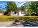 White house with a gray garage door and walkway at 2803 E Pine St, Orlando, FL 32803