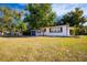 View of the front yard with curb appeal showing an updated single-story home at 2803 E Pine St, Orlando, FL 32803