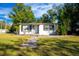 Charming home featuring a well-manicured lawn, inviting walkway, and tasteful landscaping at 2803 E Pine St, Orlando, FL 32803