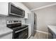 Kitchen with stainless steel appliances and white cabinets at 2803 E Pine St, Orlando, FL 32803