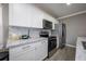 Modern kitchen featuring white cabinets, stainless steel appliances, and granite countertops at 2803 E Pine St, Orlando, FL 32803