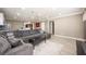 Open floor plan showcasing a comfortable living area with a gray sectional and kitchen views at 2803 E Pine St, Orlando, FL 32803