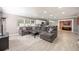 Spacious living room with gray sectional, light wood floors, and an open layout to the kitchen at 2803 E Pine St, Orlando, FL 32803
