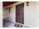 Inviting front door with secure metal gate and textured walls, complemented by a bee-themed welcome mat at 2868 N Powers Dr # 5, Orlando, FL 32818