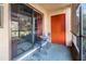 Covered patio with outdoor furniture, sliding door, and an orange door at 2868 N Powers Dr # 5, Orlando, FL 32818