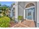 Front door with arched window and a tiled entryway at 3136 Crystal Creek Blvd, Orlando, FL 32837