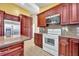 Modern kitchen with dark wood cabinets, granite countertops, and stainless steel appliances at 3136 Crystal Creek Blvd, Orlando, FL 32837