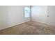 Simple bedroom with carpeted floor and neutral wall colors at 3881 Brant Pl, Leesburg, FL 34748