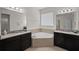 Main bathroom with double sinks and corner tub at 4032 Prairie Reserve Blvd, Orlando, FL 32824