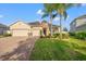 Two-story house with a three-car garage and landscaped lawn at 4032 Prairie Reserve Blvd, Orlando, FL 32824