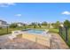 A small hot tub sits on a patio surrounded by a black metal fence and grassy lawn at 4032 Prairie Reserve Blvd, Orlando, FL 32824
