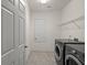 Laundry room with washer, dryer, and shelving at 4032 Prairie Reserve Blvd, Orlando, FL 32824