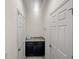 Laundry room with dark cabinets and granite countertop at 4032 Prairie Reserve Blvd, Orlando, FL 32824