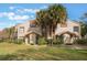 Front view of condo building, showing landscaping and entryways at 5436 E Michigan St # 4, Orlando, FL 32812