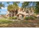 Two-story condo building with palm trees and grassy area at 5436 E Michigan St # 4, Orlando, FL 32812
