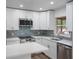 Modern kitchen with white cabinets, stainless steel appliances, and quartz countertops at 5436 E Michigan St # 4, Orlando, FL 32812