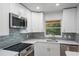 Updated kitchen featuring white cabinets and stainless steel appliances at 5436 E Michigan St # 4, Orlando, FL 32812