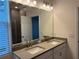 Modern bathroom with double vanity and large mirror at 642 Duke Dr, Haines City, FL 33844