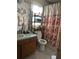 Bathroom with floral shower curtain and a wood vanity at 7262 Hickory Branch Cir, Orlando, FL 32818