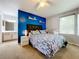Main bedroom with blue accent wall and large window at 7350 Westpointe Blvd # 224, Orlando, FL 32835
