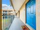 Apartment building hallway with blue door and courtyard view at 7350 Westpointe Blvd # 224, Orlando, FL 32835
